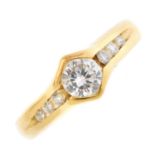 A diamond single-stone ring. The brilliant-cut diamond, within a chevron surround, to the