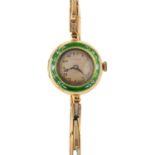 An enamel wristwatch. The circular dial with black Arabic numerals, within a green and white