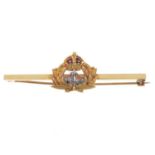 A 1960s 18ct gold military brooch. Of bi-colour design, the Royal Navy insignia with red enamel