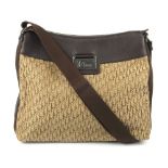 CHRISTIAN DIOR - a Trotter handbag. Crafted from beige monogram canvas and brown pebbled leather