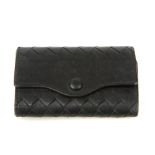 BOTTEGA VENETA - a key case. Crafted from black leather, with maker's signature woven detail, a snap