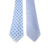 CHANEL - two silk ties. To include one pale blue tie with a four leaf clover design, together with a