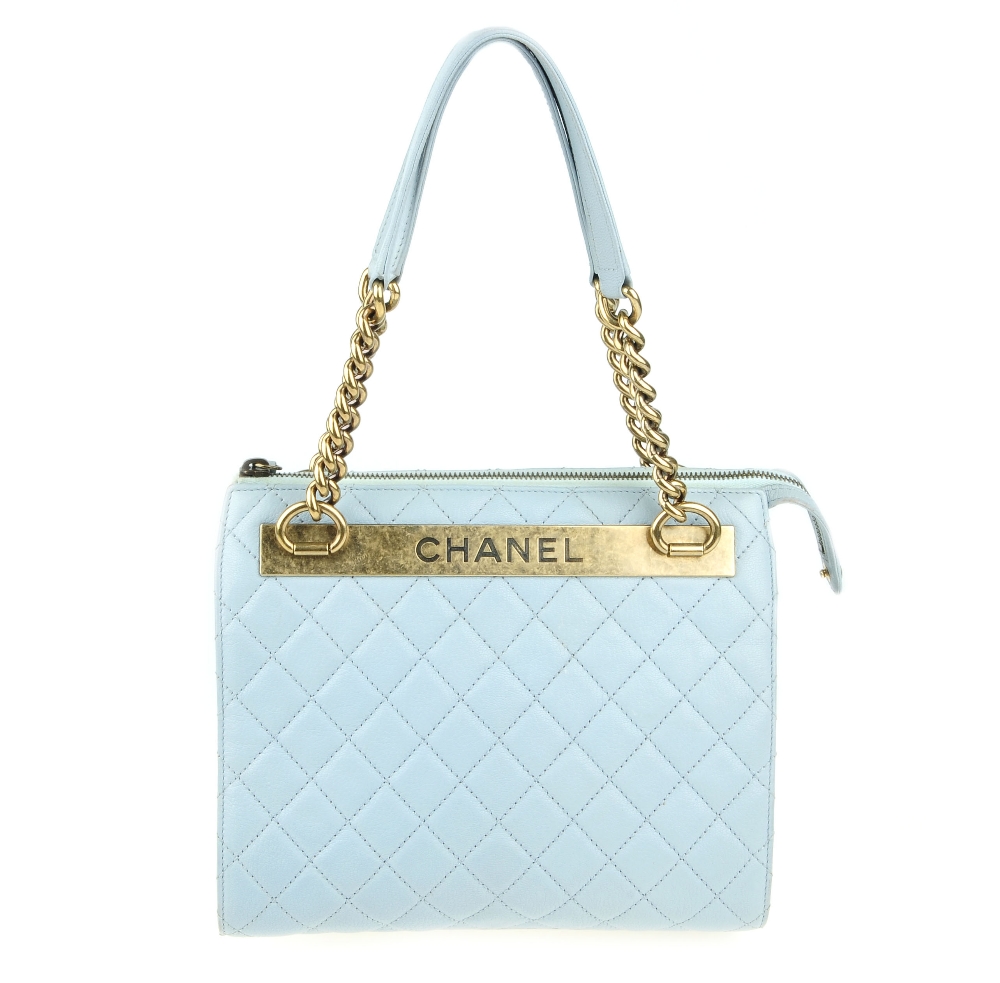 CHANEL - a quilted leather handbag. Designed with a pale blue quilted leather exterior and aged