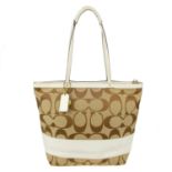 COACH - a Monogram handbag. Crafted from maker's monogram beige canvas with cream coated leather