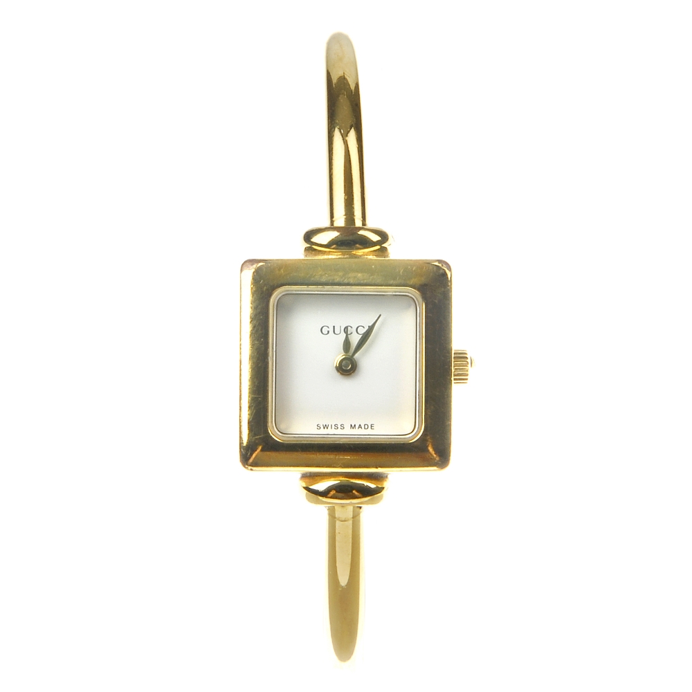 GUCCI - a lady's 1900 half bangle watch. Designed with a gold-tone square case with rounded corners,