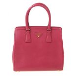 PRADA - a fuchsia pink Saffiano leather handbag. Crafted from lightly textured saffiano leather in