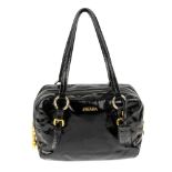 PRADA - a black patent leather handbag. Featuring flat leather handles, a fancy double layered zip