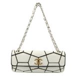 CHANEL - a black and white flap handbag. Featuring a white leather geometric pattern on a black