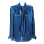 Five items of designer clothing. To include a blue silk Saint Laurent blouse, a black quilted velvet