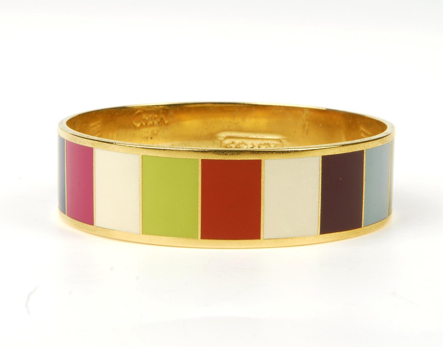 COACH - a Legacy striped bangle. The gold-tone bangle featuring multicoloured striped enamel inlay - Image 6 of 9