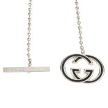 GUCCI - a necklace. Designed as a black enamelled GG monogram pendant on a silver-tone bead