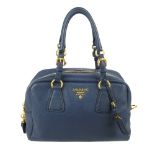 PRADA - a Bauletto bowler handbag. Crafted form blue calfskin leather, with gold-tone hardware,