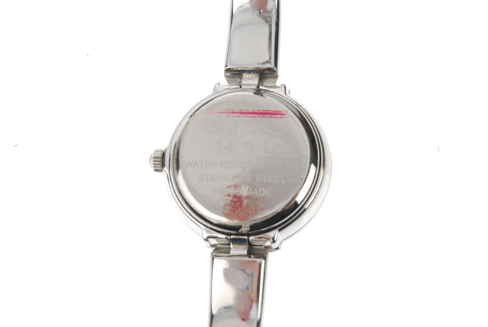 GUCCI - a stainless steel quartz lady's 1400L bangle watch. The plain black dial, with a round case, - Image 5 of 7