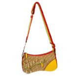 CHRISTIAN DIOR - a Rasta saddle handbag. Designed with a beige monogram canvas exterior with red,