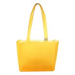 CHANEL - a rubber handbag. Crafted from yellow rubber, featuring an open top, flat top handles