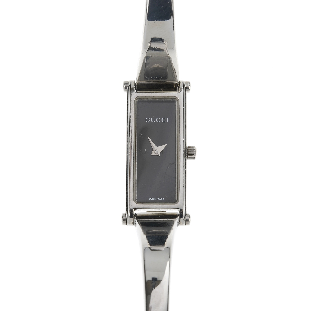 GUCCI - a stainless steel quartz lady's 1500L bangle watch. The plain black dial, with a rectangular