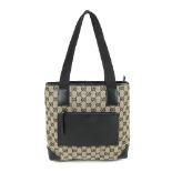 GUCCI - a canvas handbag. Designed with maker's black and beige monogram canvas exterior with smooth