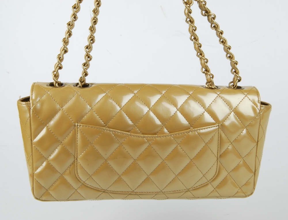 CHANEL - a gold patent leather flap handbag. Featuring a diamond quilted gold patent leather - Image 5 of 9