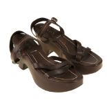 PRADA - a pair of brown calfskin platform sandals. With a crossover design and buckled ankle strap