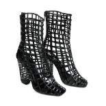 YVES SAINT LAURENT - a pair of Cage Frame ankle boots. Designed in soft black patent leather with