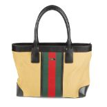 GUCCI - a canvas handbag. Crafted from camel coloured canvas with maker's signature red and green