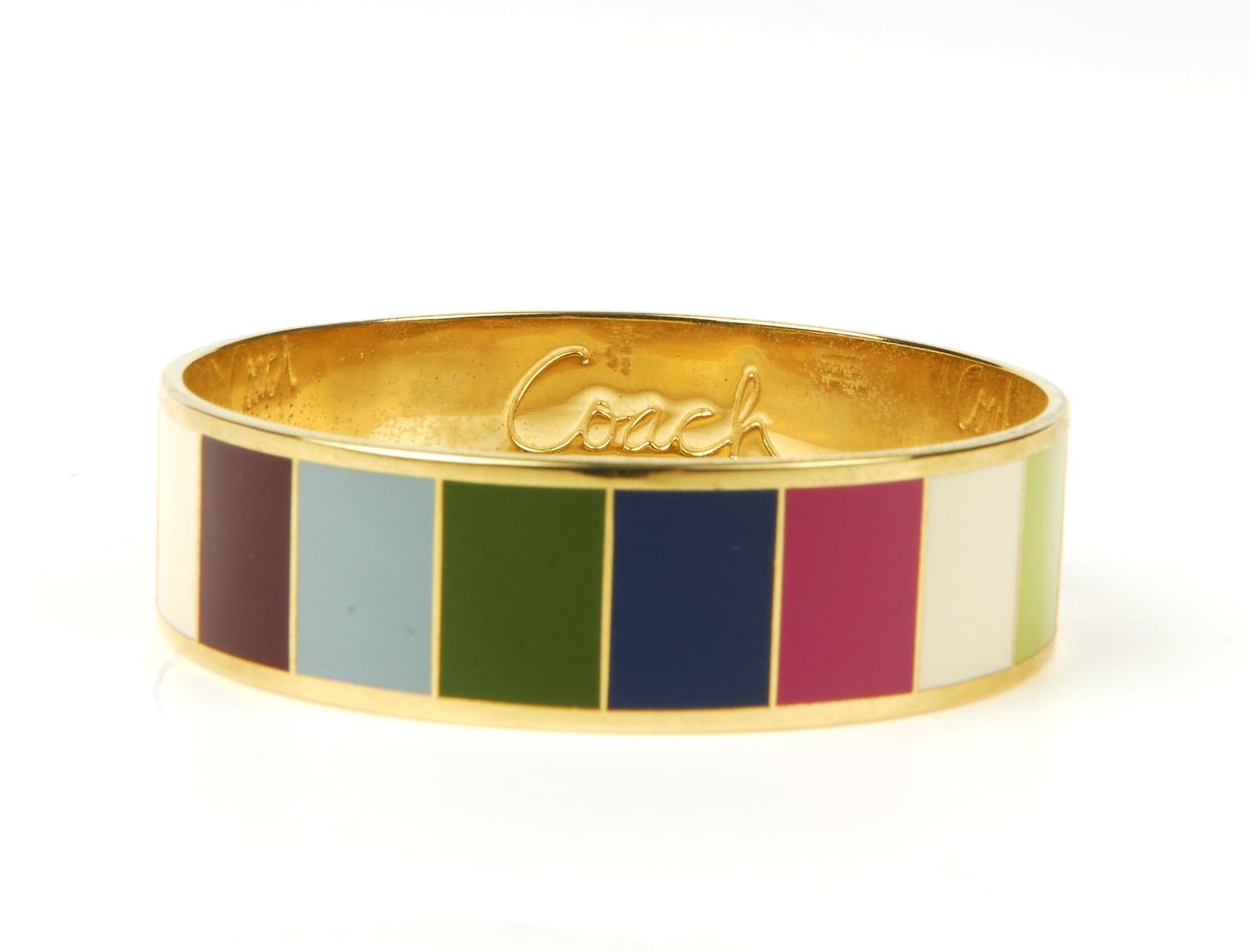 COACH - a Legacy striped bangle. The gold-tone bangle featuring multicoloured striped enamel inlay - Image 8 of 9