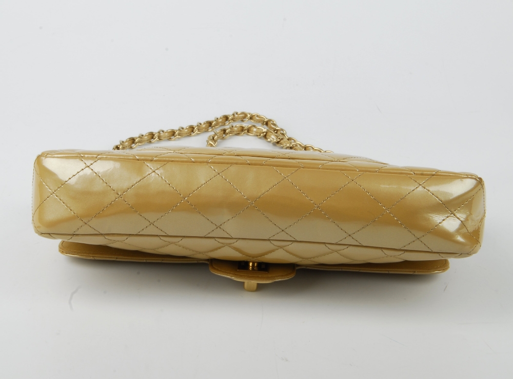 CHANEL - a gold patent leather flap handbag. Featuring a diamond quilted gold patent leather - Image 6 of 9