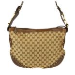 GUCCI - a Studded Pelham handbag. Crafted from beige GG canvas with grained brown leather trim,