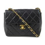 CHANEL - a Mini Classic Flap handbag. Featuring maker's signature black quilted lambskin leather