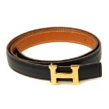 HERMÈS - a mini reversible logo buckle belt. Designed with smooth black calfskin leather to one side