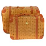 MCM - two vintage travel suitcases. To include a larger rolling suitcase, featuring maker's monogram