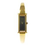 GUCCI - a lady's 1500 half bangle watch. Featuring a gold-tone rectangular case with studded hinges,