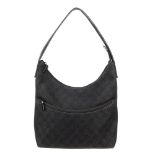 GUCCI - a black GG denim handbag. Featuring maker's black monogram denim exterior with black leather