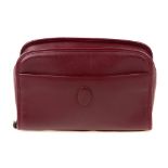 CARTIER - a Bordeaux leather cosmetics case. Designed with a burgundy leather exterior, featuring