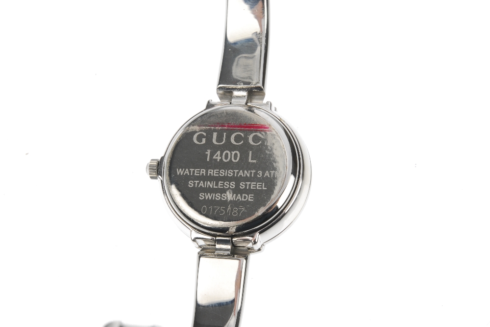 GUCCI - a stainless steel quartz lady's 1400L bangle watch. The plain black dial, with a round case, - Image 3 of 7