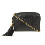 CHANEL - a vintage lambskin quilted tassel camera handbag. Crafted from diamond quilted black