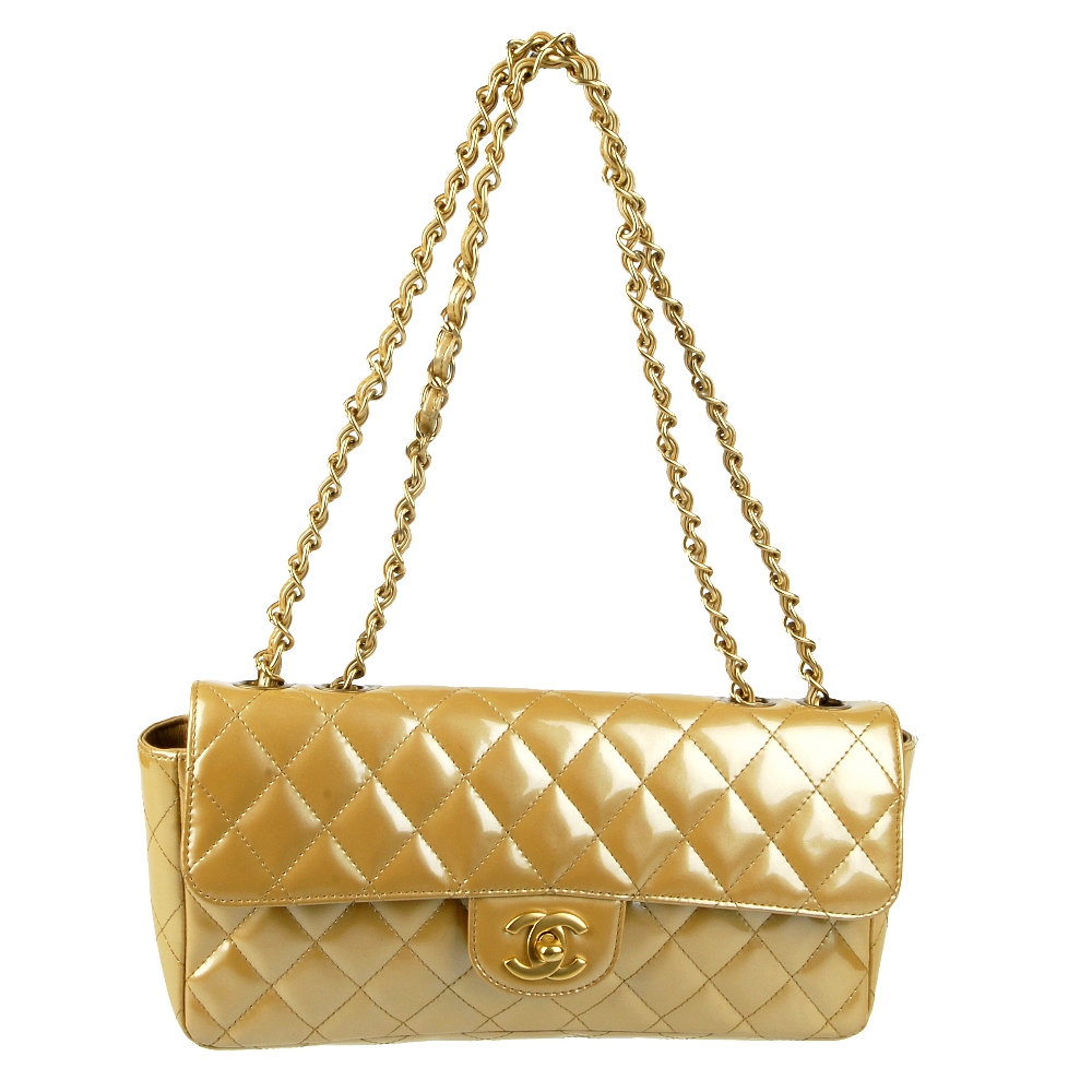 CHANEL - a gold patent leather flap handbag. Featuring a diamond quilted gold patent leather