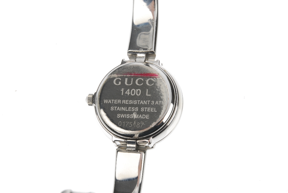 GUCCI - a stainless steel quartz lady's 1400L bangle watch. The plain black dial, with a round case, - Image 2 of 7