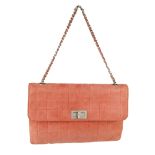 CHANEL - a vintage Chocobar handbag. Crafted from pink suede with a square quilted pattern to the