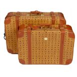 MCM - two vintage travel suitcases. To include a larger rolling suitcase, featuring maker's monogram