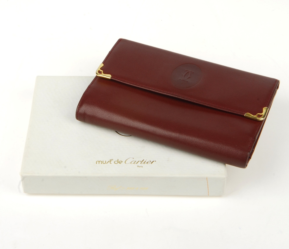 CARTIER - a Bordeaux leather purse. Designed with gold-tone corner guards and maker's embossed - Image 12 of 12