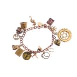 A charm bracelet. The curb-link chain, suspending sixteen charms, to include a 9ct gold cat charm