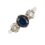 A sapphire and diamond three-stone ring. The oval-shape sapphire, with illusion-set diamond