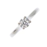 A platinum single-stone diamond ring. The brilliant-cut diamond, with tapered shoulders. Girdle