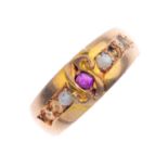 A late Victorian 15ct gold ruby and split pearl ring. The cushion-shape ruby, with scroll detail and