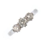 A diamond three-stone ring. The graduated brilliant-cut diamond line, with tapered shoulders and