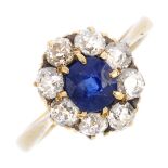 A sapphire and diamond cluster ring. The cushion-shape sapphire, with old-cut diamond surround.