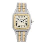 CARTIER - a Panthere bracelet watch. Stainless steel case with yellow metal bezel. Reference 1100,