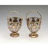 A pair of swing-handled baskets, probably George III (A/F), of circular wirework form with rope-