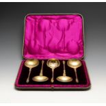 A cased Victorian silver-gilt fruit serving set of four spoons and a sugar sifter, each with